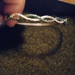 Elegant Silver and Blue Twisted Bangle With Diamond Cut Accent